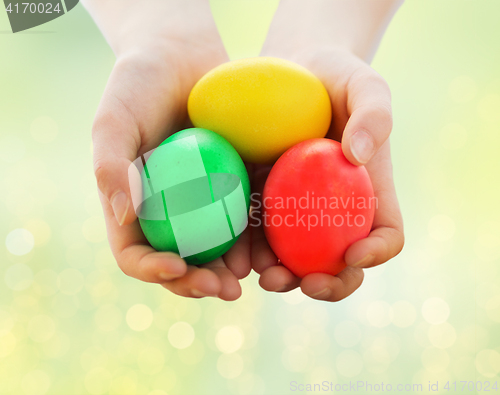 Image of close up of child hands holding easter eggs