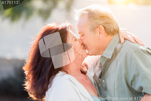 Image of Middle Aged Couple Enjoy A Romantic Slow Dance and Kiss Outside