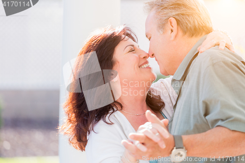 Image of Middle Aged Couple Enjoy A Romantic Slow Dance Outside