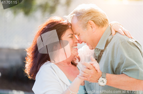 Image of Middle Aged Couple Enjoy A Romantic Slow Dance Outside