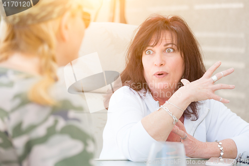 Image of Two Female Friends Enjoying Conversation Outside