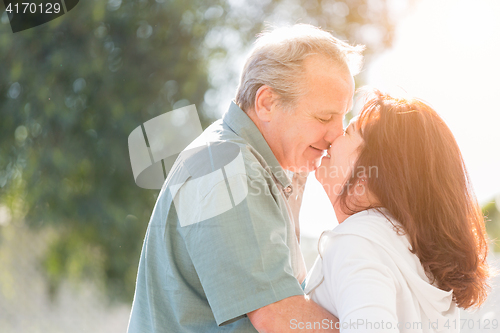 Image of Middle Aged Couple Enjoy A Romantic Slow Dance and Kiss Outside