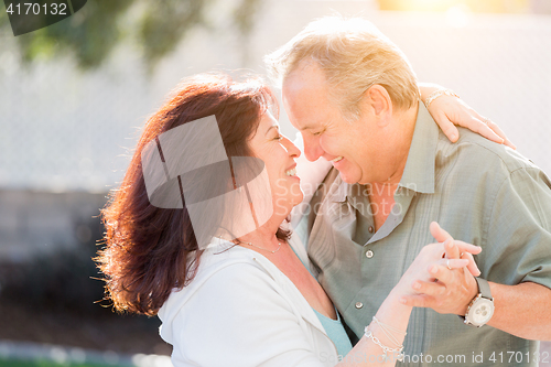 Image of Middle Aged Couple Enjoy A Romantic Slow Dance Outside