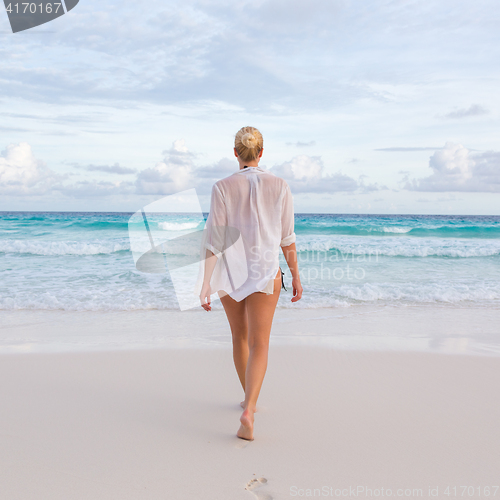 Image of Woman on summer vacations at tropical beach of Mahe Island, Seychelles.