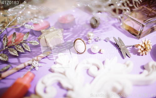 Image of Jewelry table with lot of girl stuff on it, little mess in cosmetic brushes, women interior concept, perfume elegance things, little princess makeup