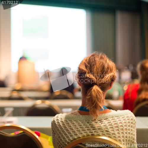 Image of Audience in lecture hall participating at business conference.