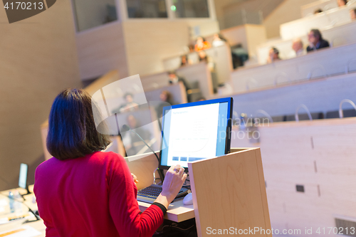 Image of Female speaker at Business Conference.