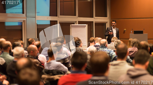 Image of Business speaker giving a talk in conference hall.