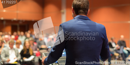 Image of Public speaker giving talk at Business Event.