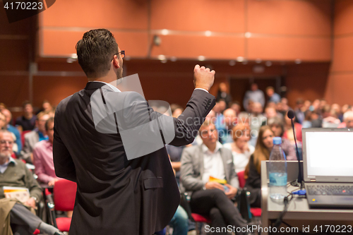 Image of Public speaker giving talk at Business Event.