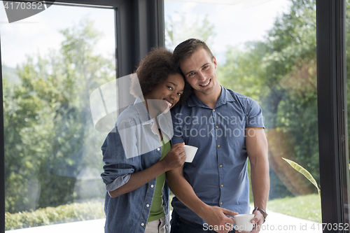 Image of romantic happy young couple relax at modern home indoors