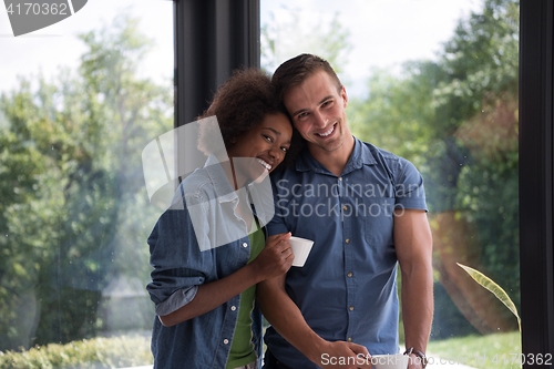 Image of romantic happy young couple relax at modern home indoors