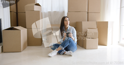 Image of Young woman relaxing with a mug of coffee