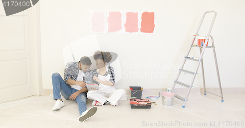 Image of Young couple use tablet to discuss colors