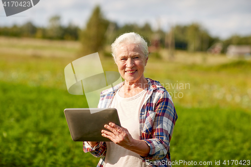 Image of senior woman with tablet pc computer at county