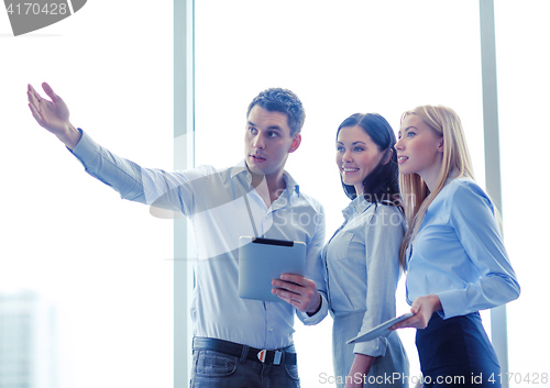 Image of business team working with tablet pcs in office