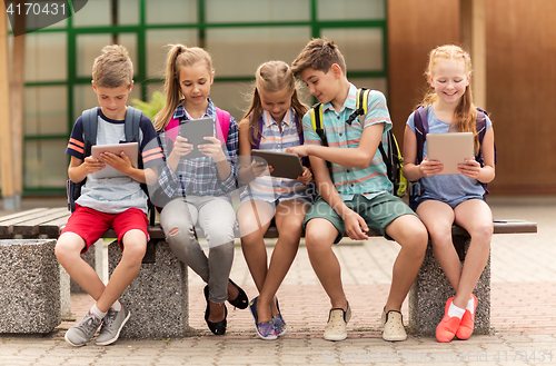 Image of group of happy elementary school students talking