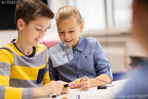 Image of happy children building robots at robotics school