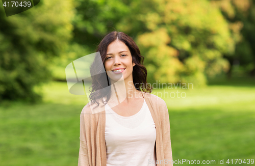 Image of beautiful happy young woman in summer park