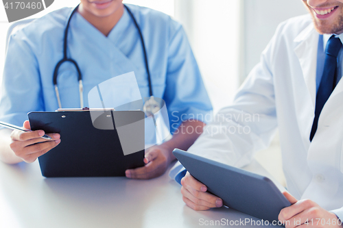 Image of doctors with tablet pc and clipboard at hospital