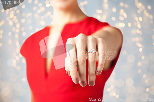 Image of close up of woman showing hand and engagement ring