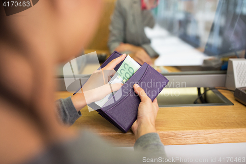 Image of hands with money at bank or currency exchanger