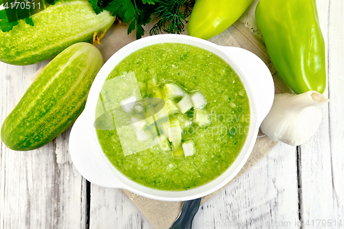 Image of Soup cucumber with peppers in white bowl on board top