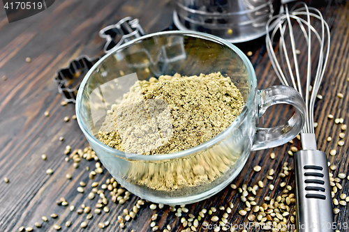 Image of Flour hemp in glass cup with mixer on dark board