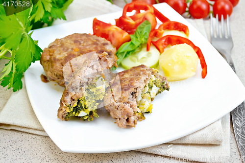 Image of Cutlets stuffed in plate on stone table