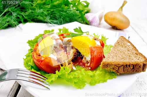 Image of Scrambled eggs in tomato with ham and mushrooms on board