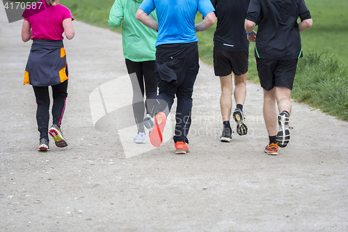 Image of Fitness sport Group of people running jogging outside on road