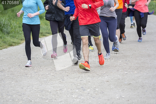 Image of Fitness sport Group of people running jogging outside on road