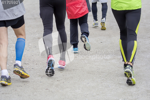 Image of Group of people running outside on road