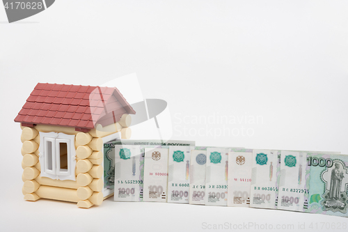 Image of Before the house lined up Russian rubles banknotes of different denomination, white background