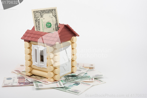 Image of House stands on the banknotes of Russian rubles, from the roof sticking out of ten US dollars banknote