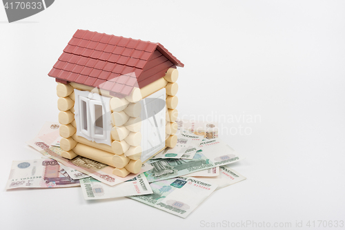 Image of House stands on the banknotes of Russian rubles, from the roof sticking out of ten US dollars banknote