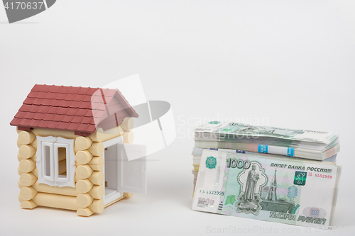 Image of Before the house lies a pack of Russian Rubles money