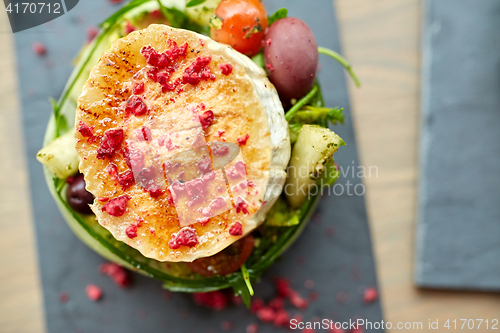 Image of goat cheese salad with vegetables at restaurant