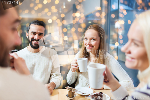 Image of happy friends meeting and drinking tea