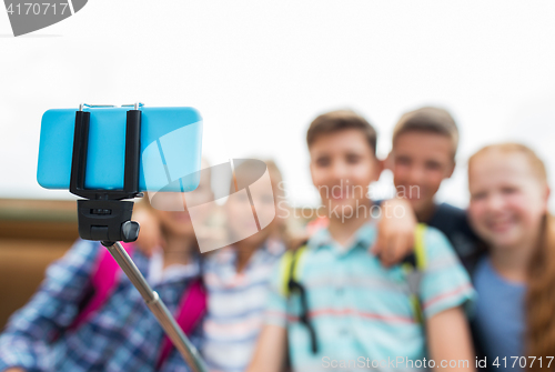Image of happy elementary school students taking selfie