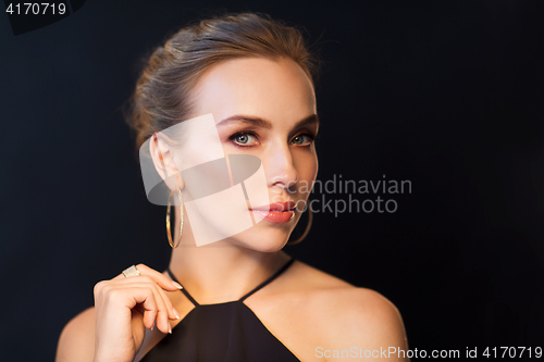 Image of beautiful woman in black wearing diamond jewelry