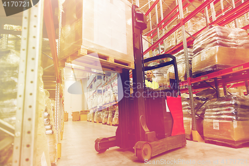 Image of man on forklift loading cargo at warehouse