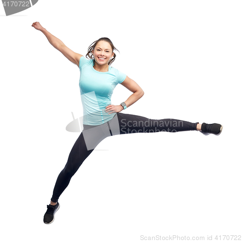 Image of happy smiling sporty young woman jumping in air