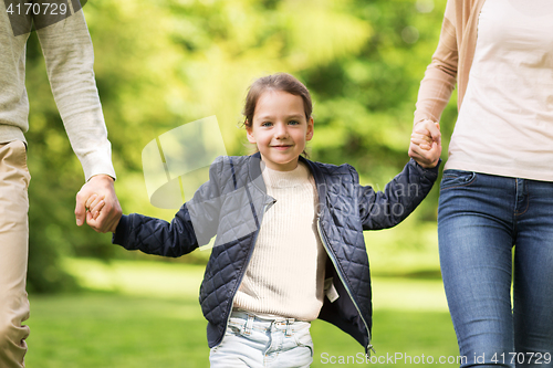 Image of happy family walking in summer park