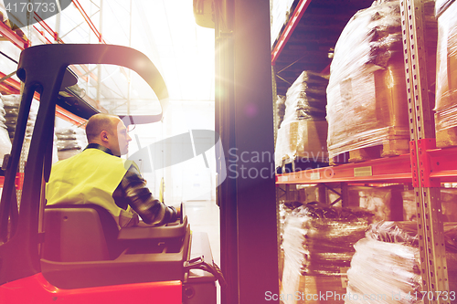 Image of man operating forklift loader at warehouse