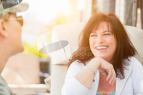 Image of Two Female Friends Enjoying Conversation Outside