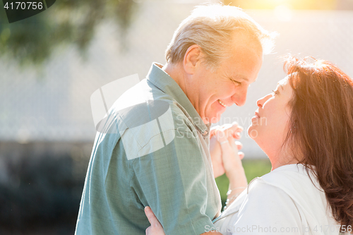 Image of Middle Aged Couple Enjoy A Romantic Slow Dance Outside