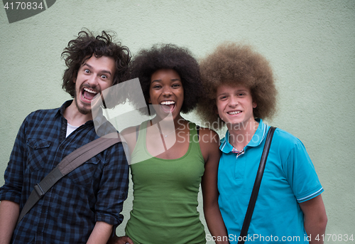 Image of multiethnic group of happy three friends