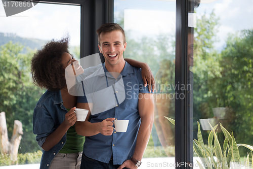 Image of romantic happy young couple relax at modern home indoors