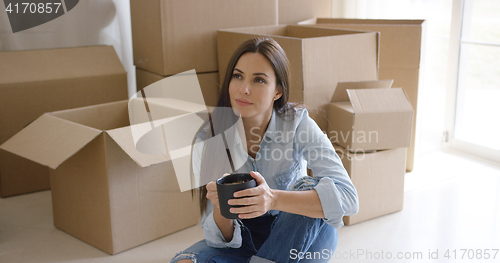 Image of Thoughtful young woman contemplating her new house